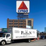 Poseidon Moving truck in Fenway MA parked in front of the iconic Citgo Sign