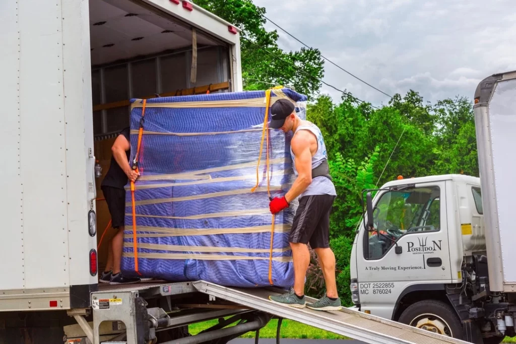 Movers off loading truck in Raleigh, NC for a long-distance move.