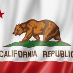 California Republic flag with a brown bear walking on grass and a red star above.