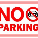 No Parking sign with a red border and car icon inside a prohibition symbol.