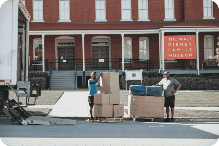 Poseidon Moving Company team offloading furniture and boxes from a branded moving truck at customer destination