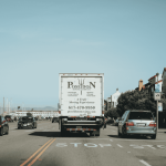 Poseidon Moving Company truck driving into the distance on an open road
