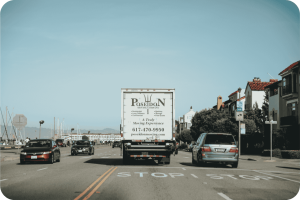 Poseidon Moving Company truck driving into the distance on an open road