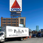 Poseidon Moving truck near Citgo sign in Boston, preparing for long-distance move to New York City