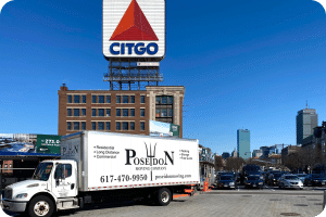 Poseidon Moving truck near Citgo sign in Boston, preparing for long-distance move to New York City