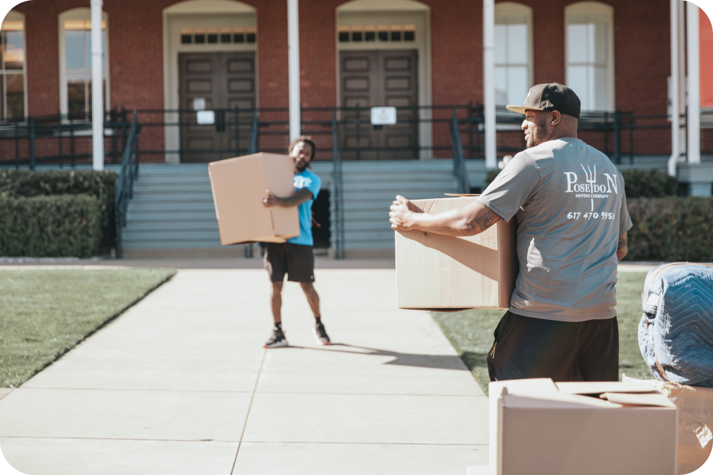 Poseidon Moving Company team carrying boxes during a move on a sunny day.