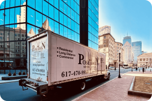 Poseidon Moving Company truck parked in downtown Boston near historic buildings and offices.