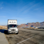 Poseidon Moving Company truck parked on the road during a long-distance move