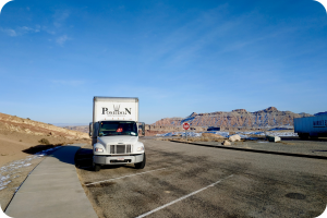 Poseidon Moving Company truck parked on the road during a long-distance move