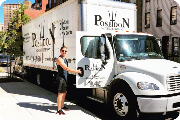 Poseidon Moving Foreman with Moving Truck Poseidon Moving foreman standing beside branded moving truck on a city sidewalk