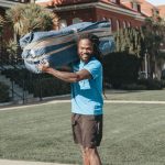 Poseidon mover carrying a blanket-wrapped item during a move